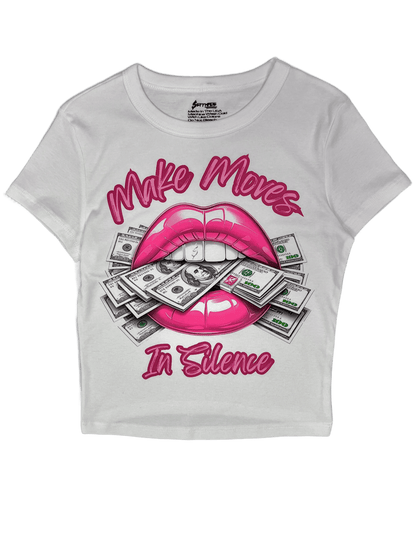 White Make Moves in Silence women’s baby tee featuring a bold hot pink lips-and-money graphic with the words “Make Moves in Silence.” Women’s graphic T-shirt and women’s crop top by SESMade.